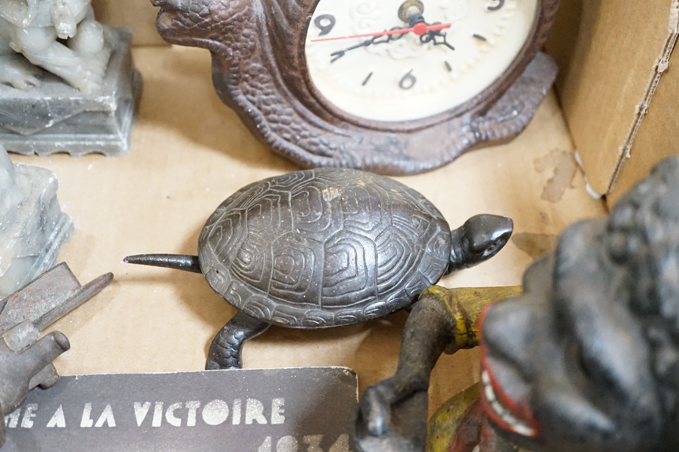 A metal figural money box, a pair of hardstone temple dogs, a novelty snail clock, metal tools and a United Artists 1930 illustrated magazine